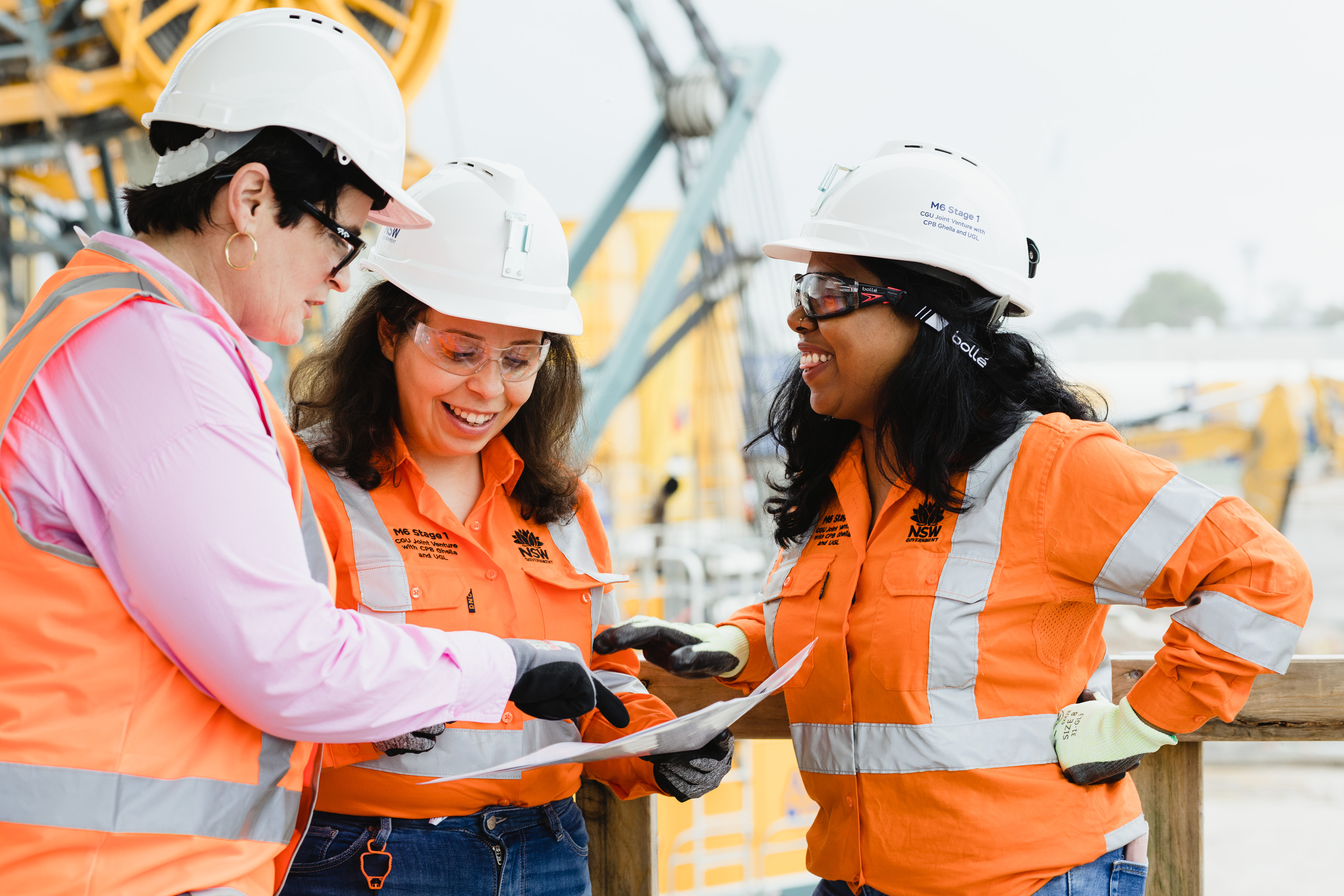 Goup shot of three women in high vis vest on a construction site